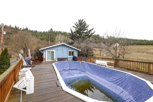 view of pool featuring area for grilling and a deck