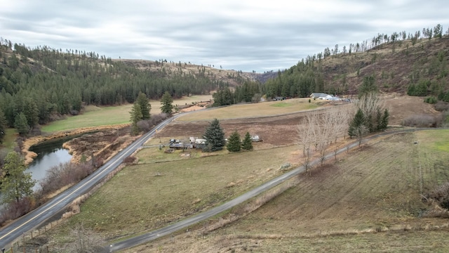 birds eye view of property with a rural view and a water and mountain view