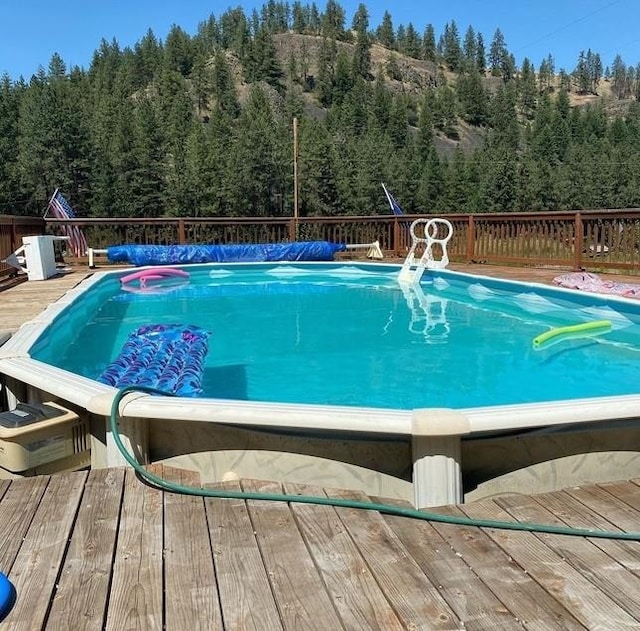 view of pool featuring a wooden deck