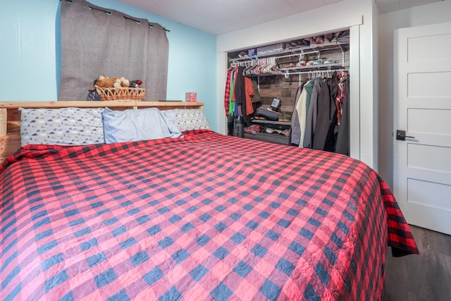 bedroom featuring hardwood / wood-style floors and a closet