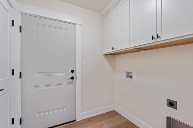 clothes washing area featuring electric dryer hookup, hookup for a washing machine, cabinets, and light wood-type flooring