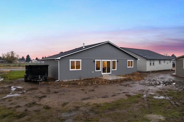 view of back house at dusk