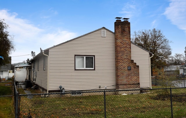 view of side of property featuring a yard and cooling unit