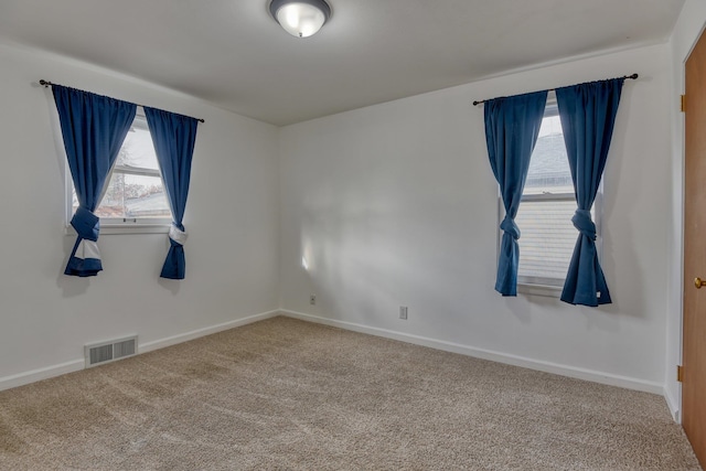 unfurnished room featuring carpet flooring and a healthy amount of sunlight