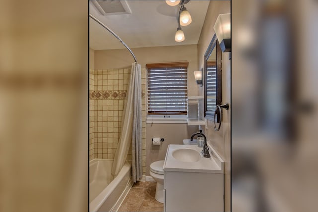 full bathroom with tile patterned flooring, shower / bath combo with shower curtain, vanity, and toilet