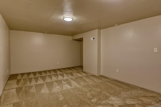 basement featuring light carpet