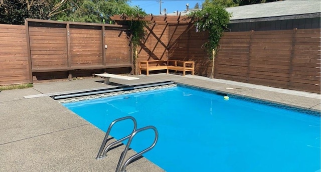 view of pool featuring a diving board