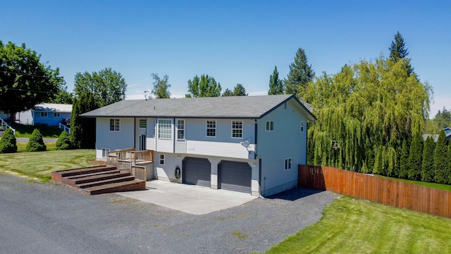 view of front of house featuring a garage and a front lawn