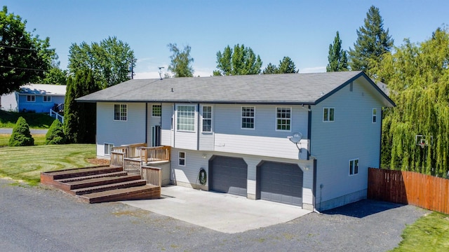 view of front facade with a garage and a front lawn