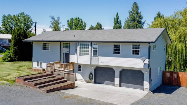 split foyer home with a front lawn and a garage