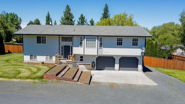 bi-level home with a front yard and a garage