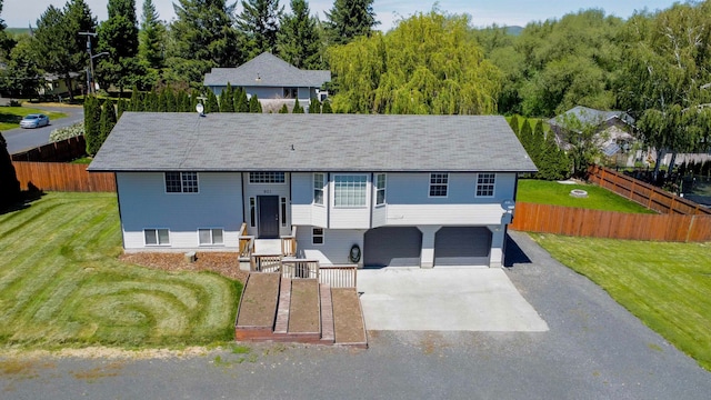 split foyer home with a front yard and a garage