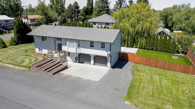 view of front of house with a garage and a front lawn