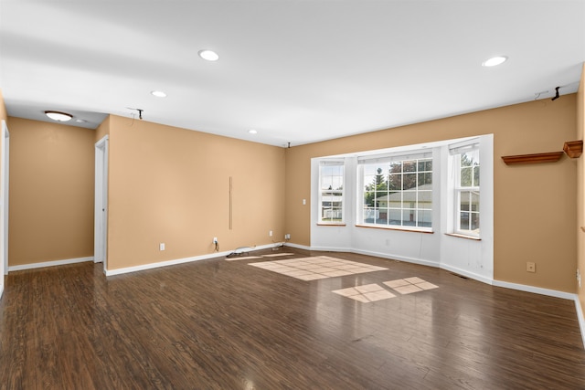 spare room with dark hardwood / wood-style flooring