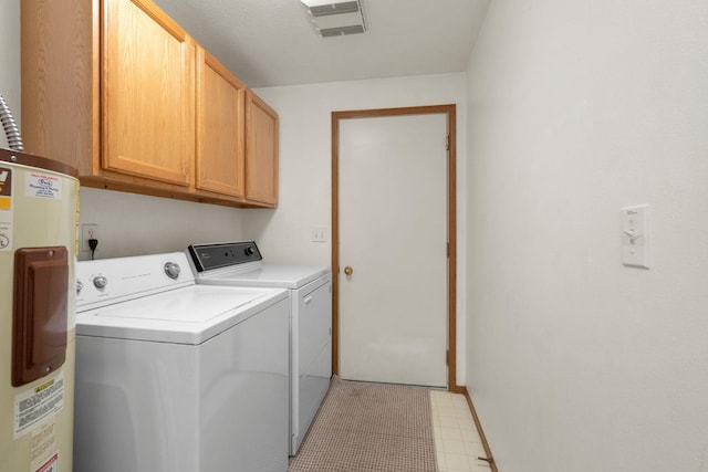 washroom featuring washer and dryer, cabinets, and electric water heater