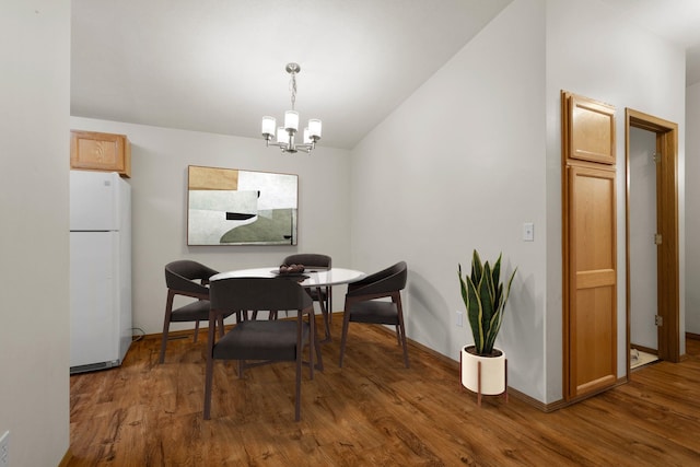 dining area with a chandelier and dark hardwood / wood-style floors