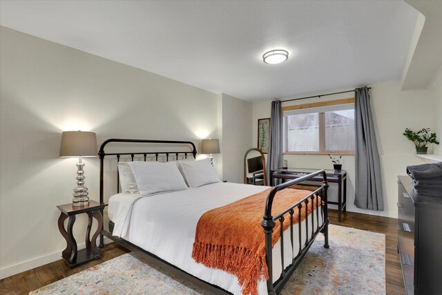 bedroom with hardwood / wood-style flooring, ceiling fan, and a textured ceiling