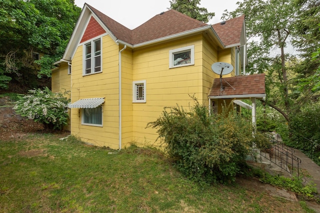 view of property exterior featuring a lawn