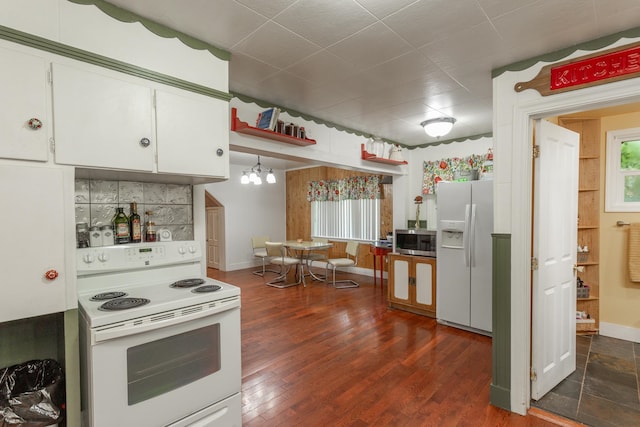 kitchen featuring white cabinets, dark hardwood / wood-style flooring, white appliances, and a chandelier