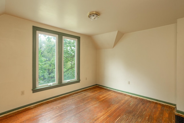 bonus room featuring wood-type flooring and vaulted ceiling