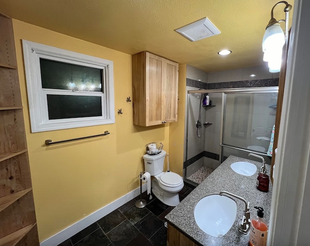 bathroom featuring walk in shower, tile patterned flooring, a textured ceiling, toilet, and vanity