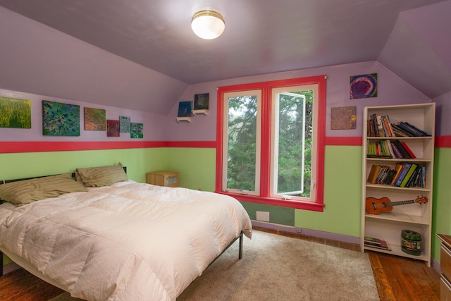 bedroom with dark wood-type flooring and vaulted ceiling