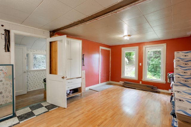 interior space featuring beamed ceiling and wood-type flooring