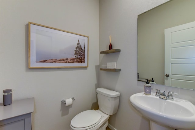 bathroom featuring toilet and sink