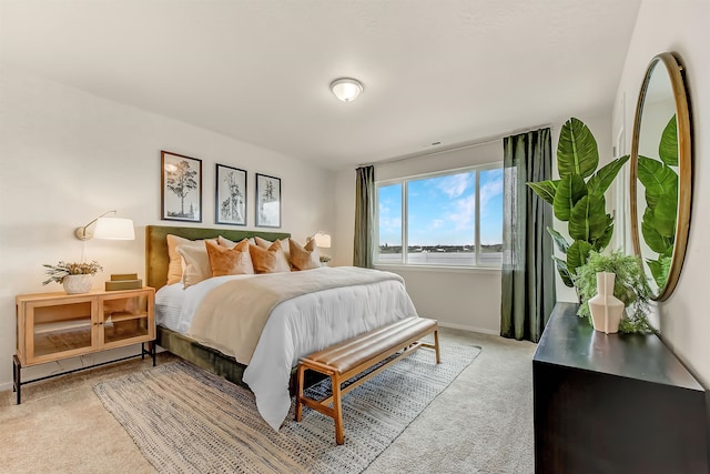 bedroom featuring light carpet