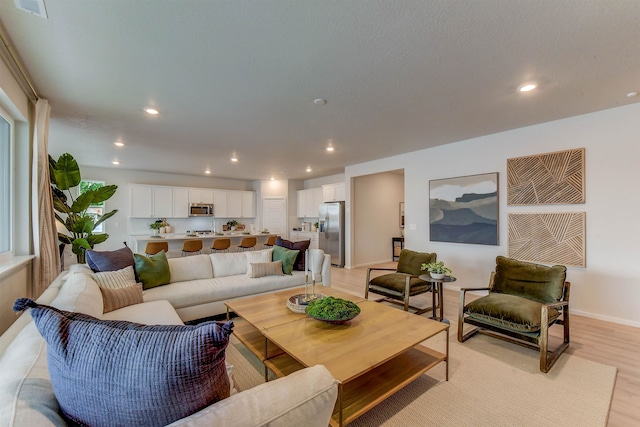 living room with light hardwood / wood-style flooring