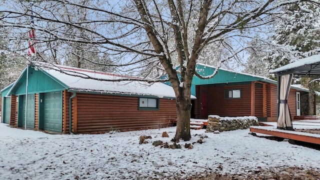 log cabin featuring a garage and a front lawn