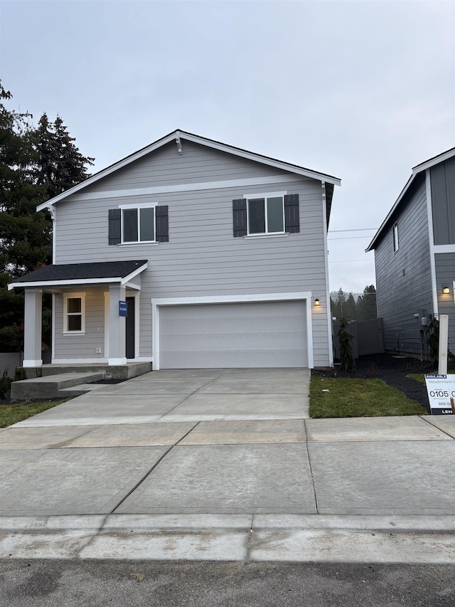 view of property featuring a porch and a garage