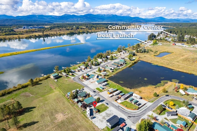 birds eye view of property with a water and mountain view