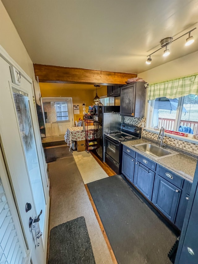 kitchen featuring black electric range oven, sink, backsplash, and a wealth of natural light