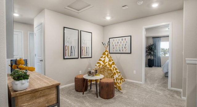 sitting room featuring light colored carpet