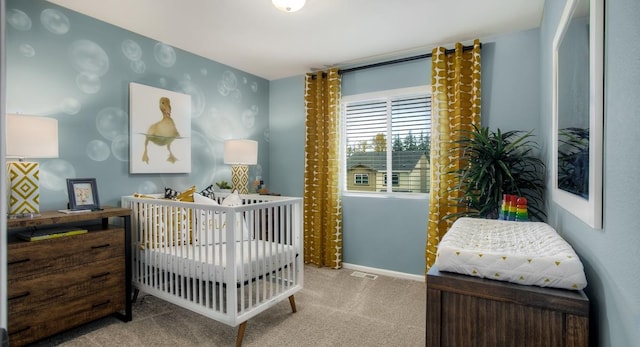 carpeted bedroom with a nursery area