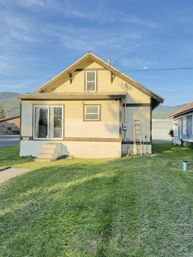 202 S Central Ave, Ione, WA 99139 - view of property exterior featuring a yard and entry steps