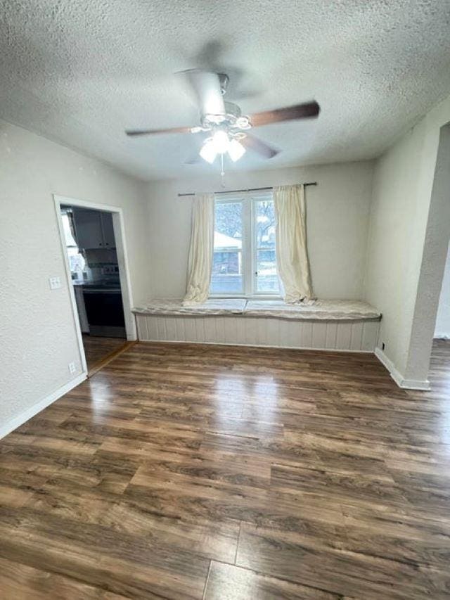 spare room featuring a textured ceiling, dark hardwood / wood-style floors, and ceiling fan