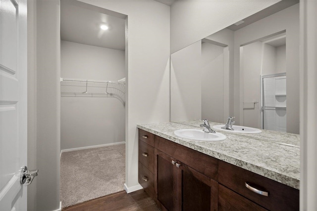 bathroom with vanity, hardwood / wood-style flooring, and an enclosed shower