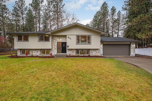 split foyer home featuring a front lawn and a garage