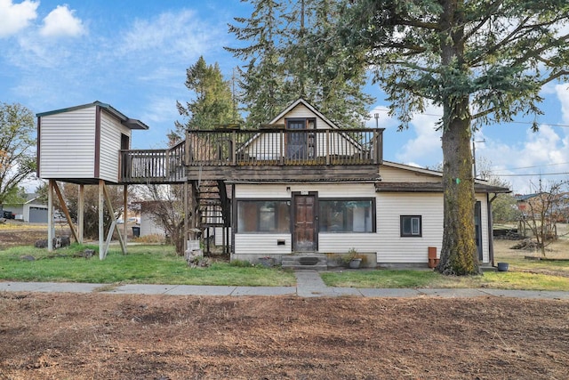 rear view of property featuring a lawn