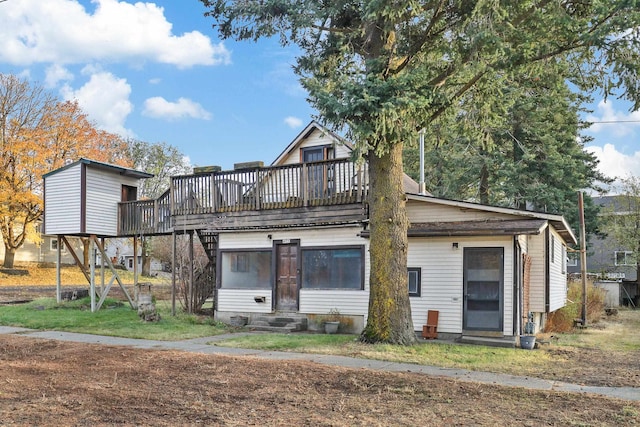 back of property featuring a balcony