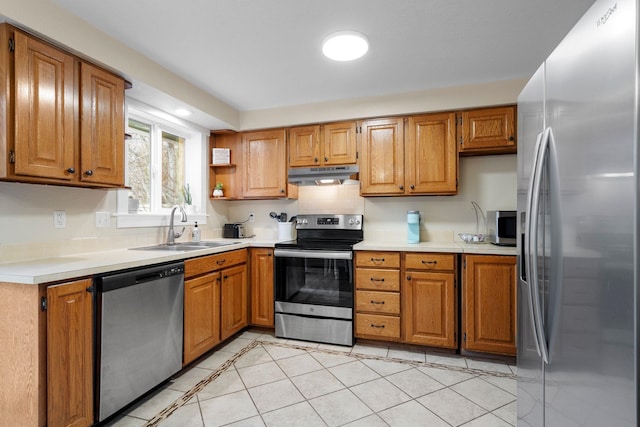 kitchen featuring tasteful backsplash, sink, light tile patterned flooring, and appliances with stainless steel finishes