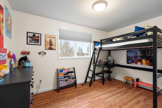 bedroom featuring wood-type flooring