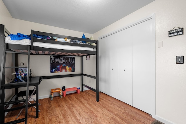 bedroom featuring a closet and light hardwood / wood-style flooring