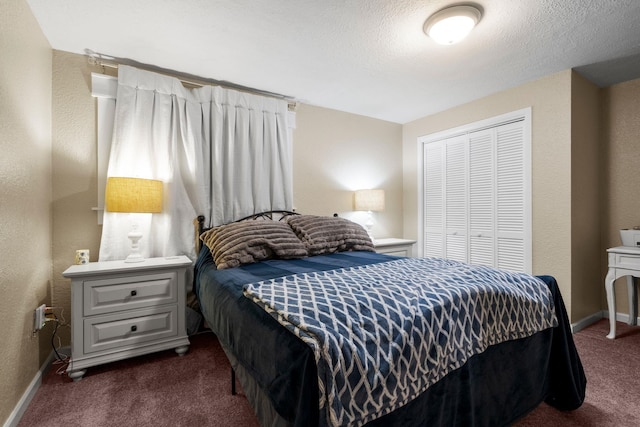 carpeted bedroom with a textured ceiling and a closet