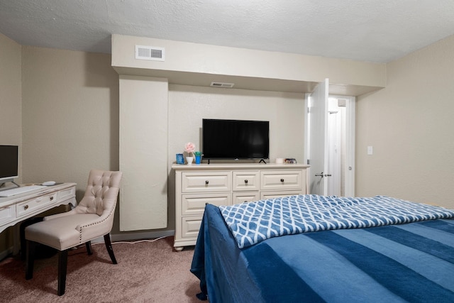 carpeted bedroom featuring a textured ceiling