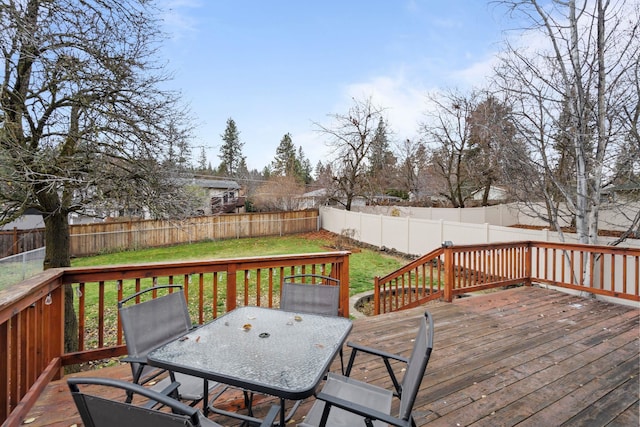 wooden deck featuring a yard