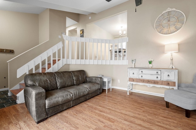 living room featuring lofted ceiling and light wood-type flooring