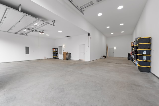 garage featuring electric panel and a garage door opener